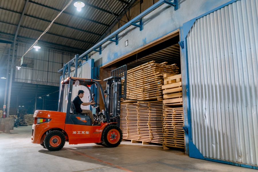 Forklift moving stacked pallets, how sod is loaded for delivery
